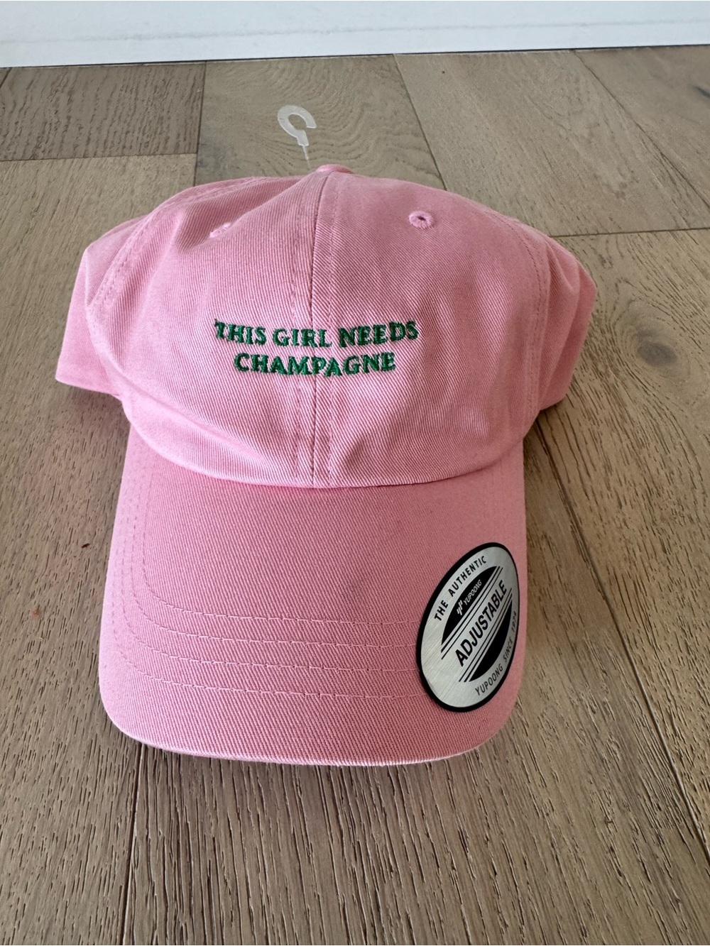 The Refined Spirit THIS GIRL NEEDS CHAMPAGNE CAP Pink Adjustable $54